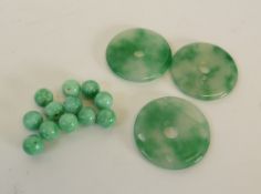 THREE CHINESE DYED GREEN HARD STONE PIERCED DISC TOGGLES, 1 5/8" diameter AND APPROX 54 UNSTRUNG