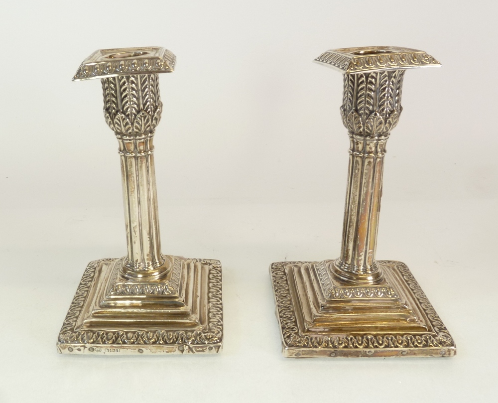 A PAIR OF WEIGHTED SILVER CANDLESTICKS, in the form of classical columns, with removable square