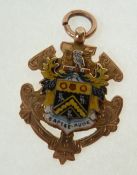 A 9CT GOLD AND ENAMEL SHEILD MEDALLION, ENAMELLED WITH ARMS OF OLDHAM COUNTRY BOROUGH COUNCIL,