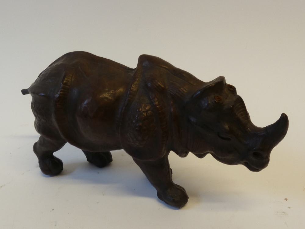 A LEATHER CLAD MODEL OF A RHINOCEROS, AFTER ALBRECT DURER, 12 ½"" (31.8cm) high, 6"" (15.2cm)