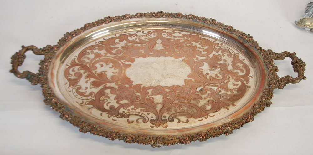 A LATE NINETEENTH CENTURY SHEFFIELD PLATE OVAL TWO HANGLED TRAY, with moulded floral boarder and