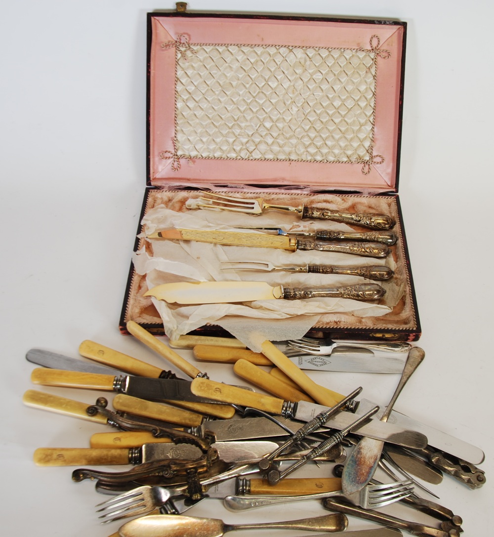 A CONTINENTAL ELECTROPLATE CARVING SET OF FIVE PIECES with rococo embossed handles, in case, FOUR