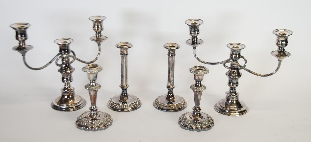 A PAIR OF PRESTONS ELECTROPLATED CANDLE STICKS, with floral embossed borders, A PAIR OF THREE LIGHT