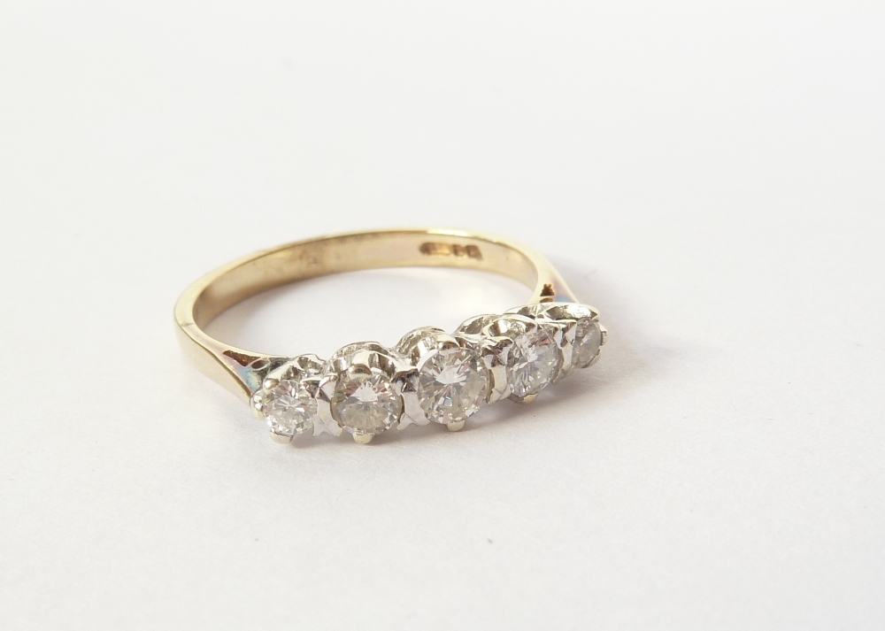 9ct GOLD RING, set with five small brilliant cut diamonds