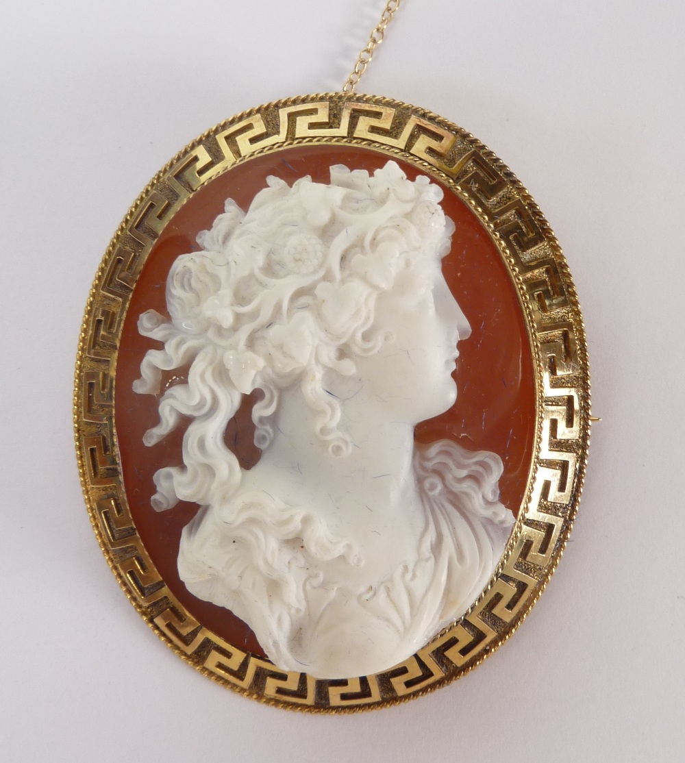 A GOOD MID VICTORIAN CARVED SARDONYX CAMEO BROOCH OF A BACCHANTE IN PROFILE, her hair garlanded
