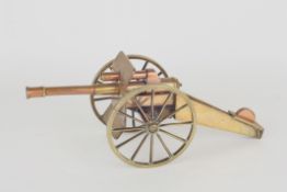 A WWI Trench art brass and copper gun carriage, with copper barrel, large wheels and a box-section