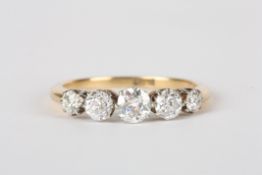 A five stone diamond ring set in 18ct yellow gold and platinum, the central stone of approximately