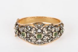 A 19th century style gold coloured metal diamond and tourmaline stiff bangle, probably