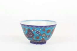 An unusual 19th century Chinese porcelain and cloisonné tea bowl, the blue and white interior