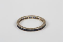 A white metal and sapphire eternity ring, with chased mounts, size P