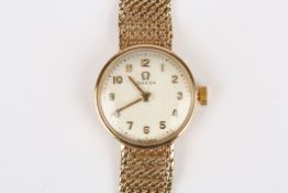 A ladies 9ct gold Omega wristwatch, on mesh bracelet, with guarantee, length 8cm