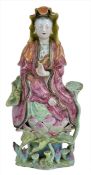 A 18th/19th century Chinese porcelain figure of Guanyin, in seated position with arm raised and