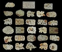 A collection of 28 early/mid 20th century carved jade coloured nephrite discs, of various pierced