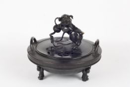 A late 19th/20th century Chinese bronze tripod censer, of circular form with upright loop handles,