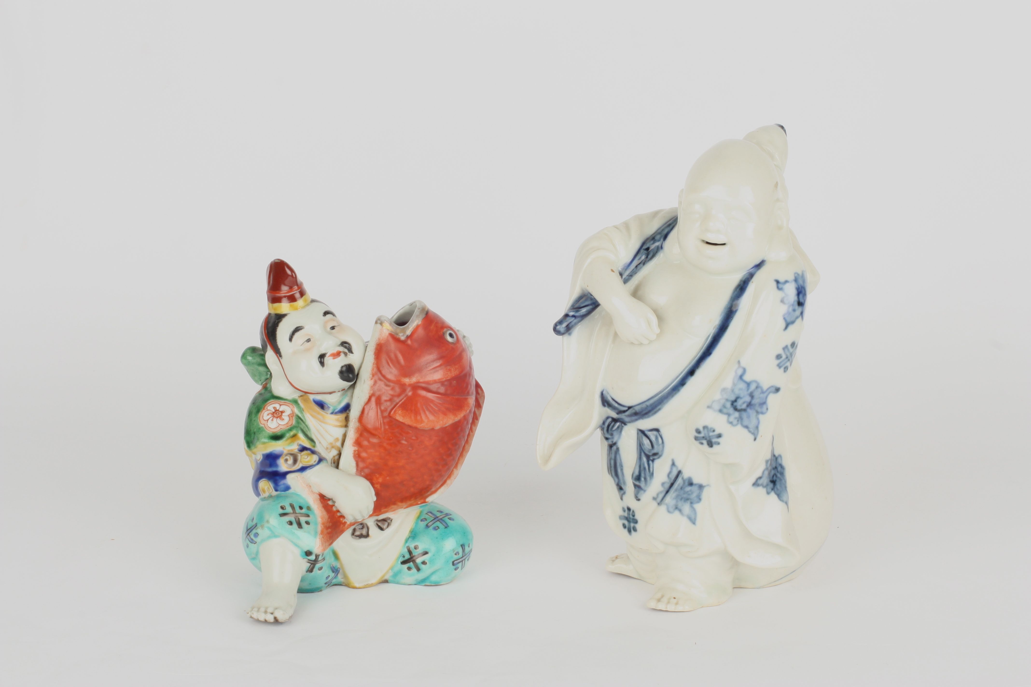 Two 20th century Chinese porcelain figures, one blue and white figure of Buddha in standing pose,