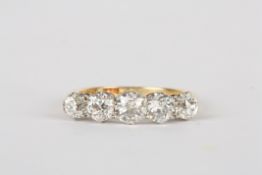 A five stone diamond ring set in 18ct yellow gold and platinum, the central stone of approximately