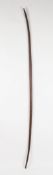 A late 19th century African Nigerian tribal recurve bow, the shaft of smooth carved and curved