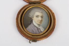 A 19th century oval miniature of a gentleman on ivory, wearing a blue jacket and white lace cravat