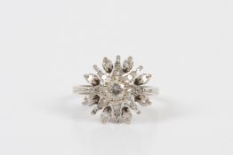 An 18ct white gold and diamond star burst ring, the central diamond of approximately 0.25cts and