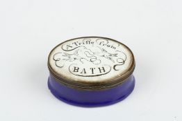 A 19th century enamel pill box ?A Trifle from Bath?, of oval form with metal frame, black and white