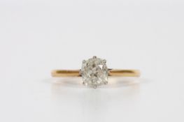 An 18ct gold and platinum solitaire ring, cushion cut, approximately one carat, in claw setting,