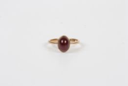 A 9ct gold and cabochon garnet ring, with rub over setting, size K½  Good condition.