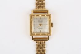 A Precimax 18ct yellow gold ladies wrist watch, with mechanical movement, silvered dial with baton