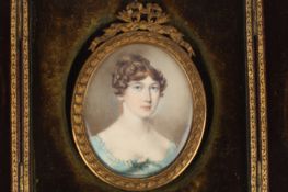 An early 19th century miniature portrait of a young lady, painted on ivory, the sitter with