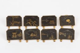 A set of eight Japanese brass menu holders, early 20th century, each decorated in the Japanned