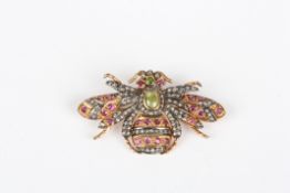 A gold coloured metal and gem set bee brooch, the bee shaped brooch set with numerous rose