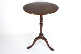 A mahogany tilt top tripod table, with central column and three splayed legs, 76cm high  In good