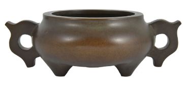 A Chinese bronze tripod censer, of squat circular form, four character mark to base, 16cm diameter