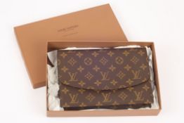 A Louis Vuitton clutch bag, in traditional Louis Vuitton logo material, with popper type clasp,