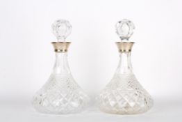 An Elizabeth II pair of silver topped cut glass ship decanters, hallmarked Birmingham 1975 with