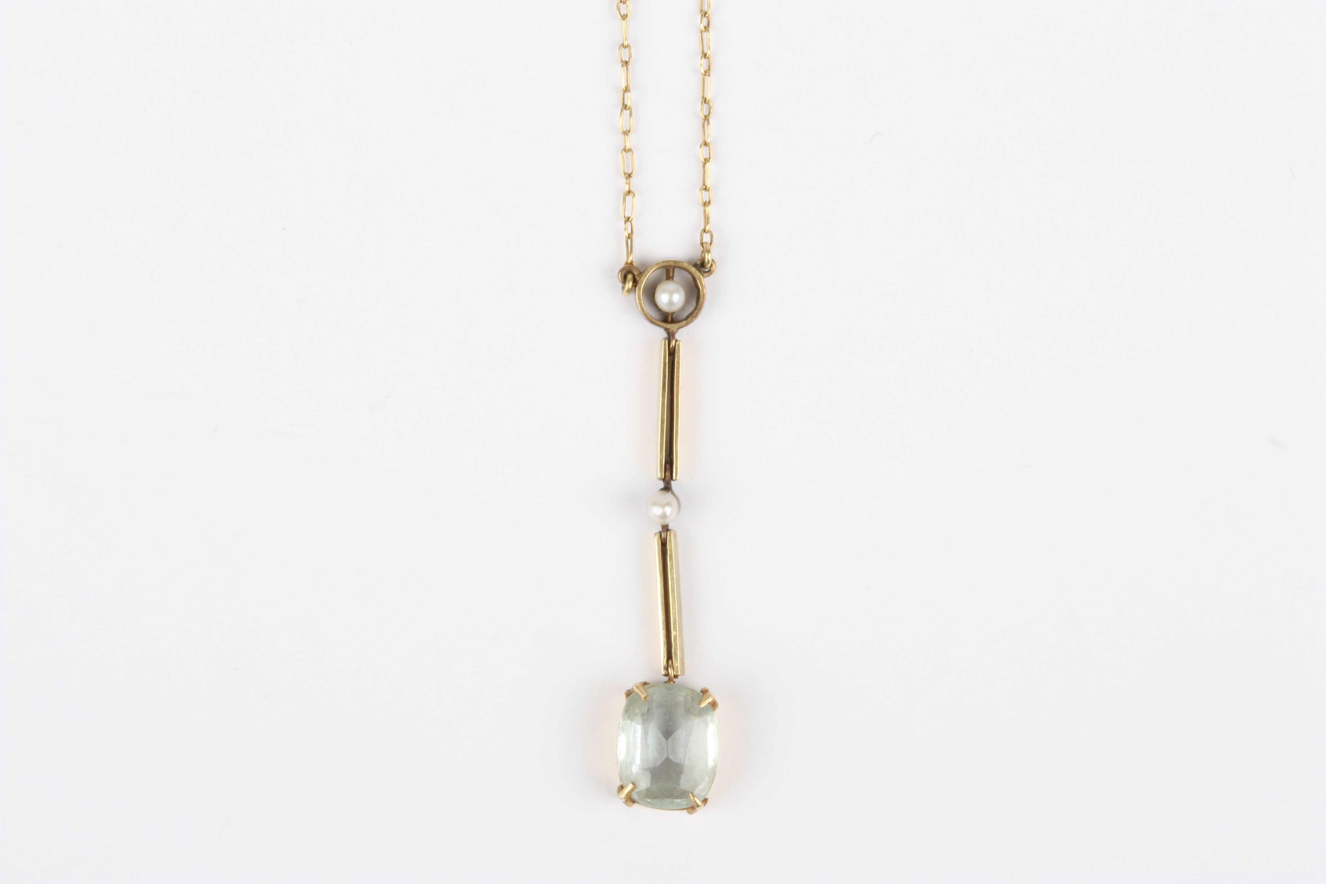 An Edwardian 15ct gold and aquamarine pendant, set with small seed pearls and large oval suspended