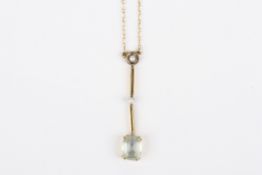 An Edwardian 15ct gold and aquamarine pendant, set with small seed pearls and large oval suspended