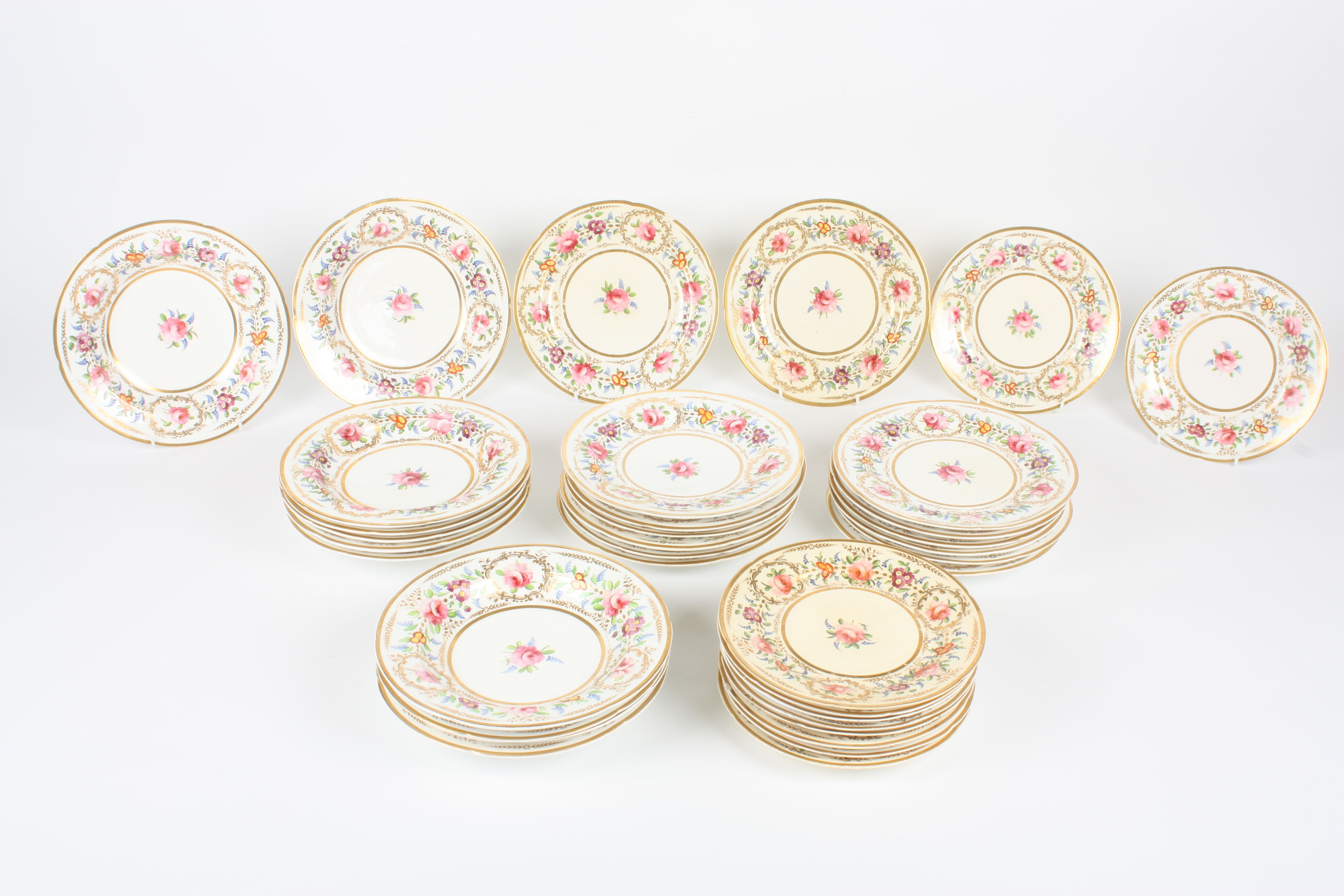 A set of Coalport Felspar porcelain plates, painted with flowers and gilt highlights, comprising: