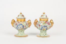 A pair of early 19th century porcelain vase shaped inkwells, formed as a lidded bulbous urn and