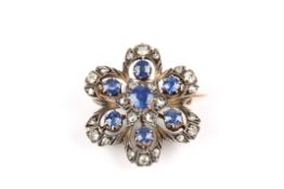 An Edwardian gold, diamond and sapphire flower head pendant brooch, with central sapphire of