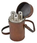 A leather cased cylindrical travelling decanter set, containing three shaped glass bottles with