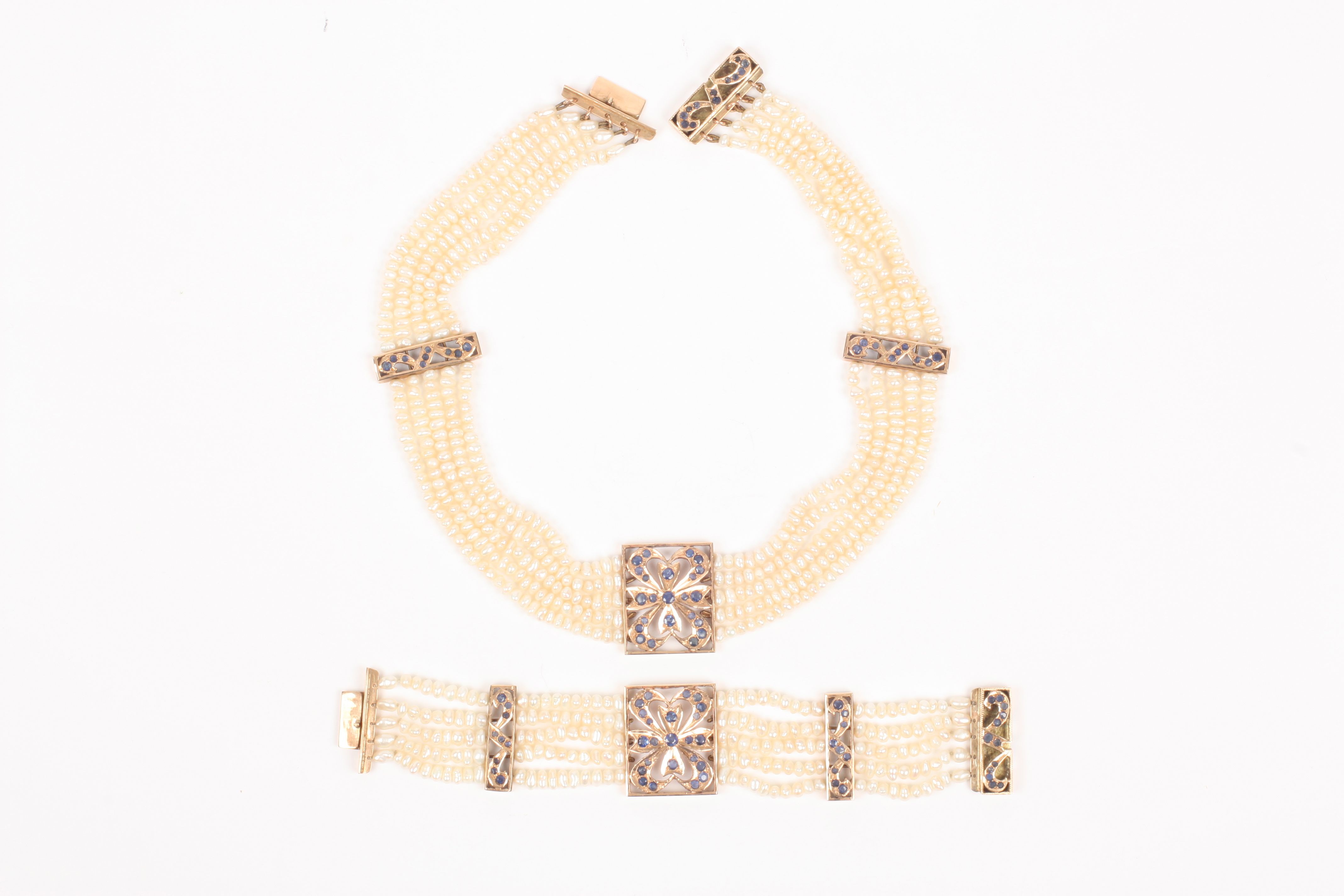A pearl, sapphire and gold coloured necklace and matching bracelet set, the five strand pearl
