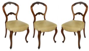 A set of three Victorian mahogany single chairs, with carved and scrolled foliate frames,