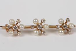 An Edwardian gold triple flower head bar brooch, set with diamonds and seed pearls, 2.9 grams  Good