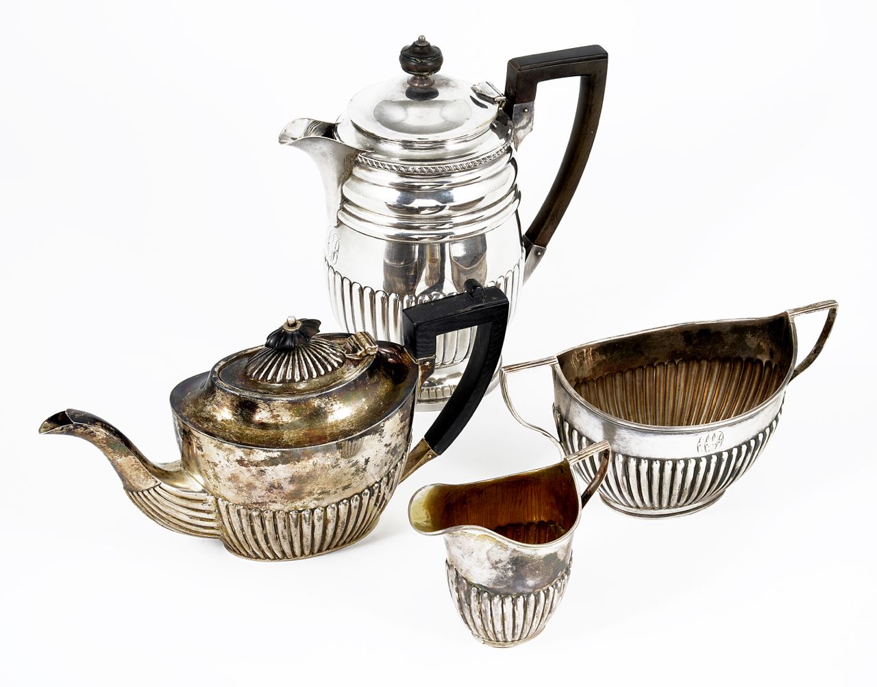 A silver 3 piece tea set with associated coffee pot, comprising coffee pot, tea pot, sugar bowl and