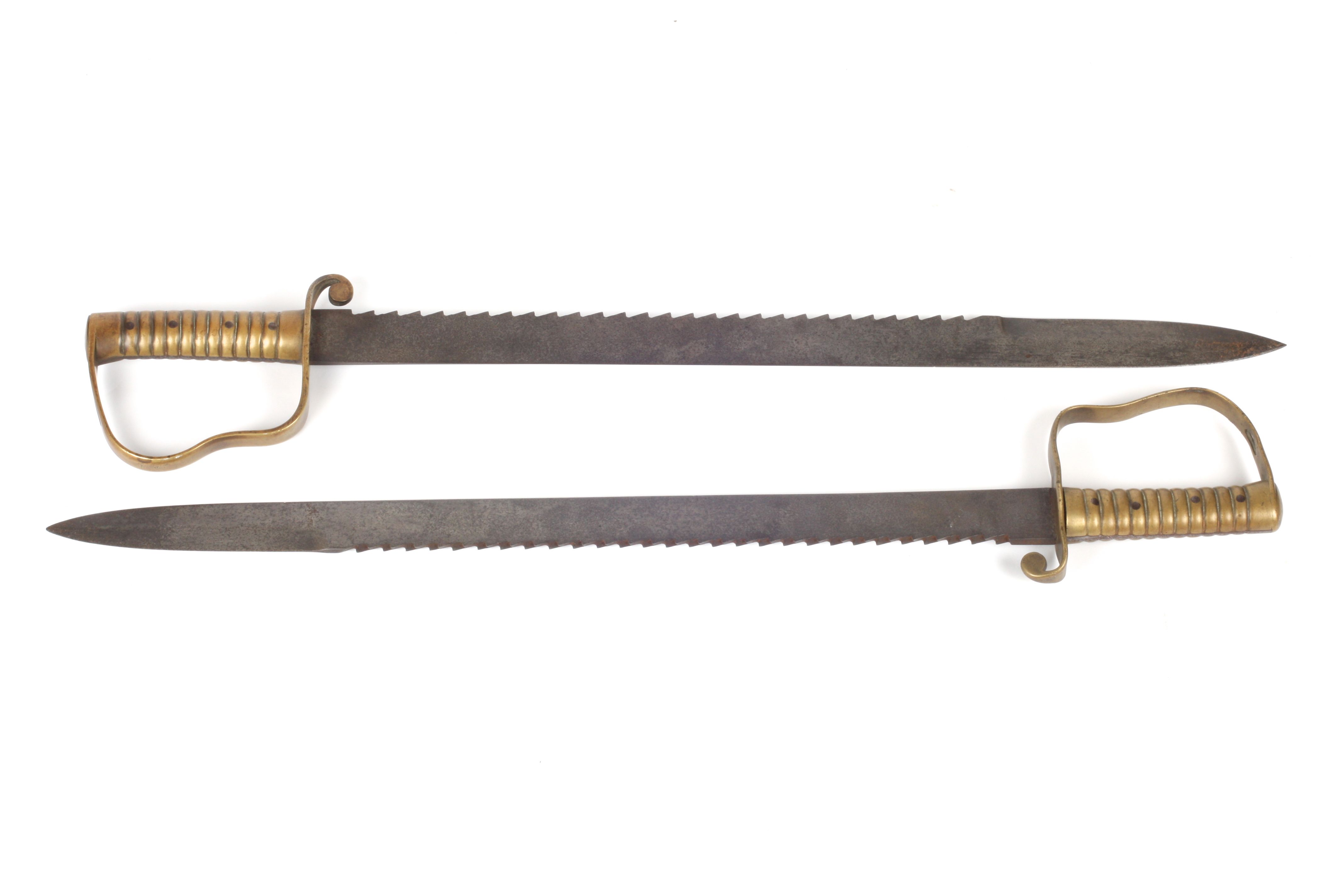 Two British pattern 1856 pioneer saw back swords, one blade stamped Wilkinson, London, with brass