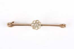 A gold and diamond flower head bar brooch, set with small rose-cut diamonds, unmarked, 2.1 grams