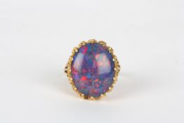A gold coloured metal dress ring set with opal doublet, in claw setting, size Q  In good overall