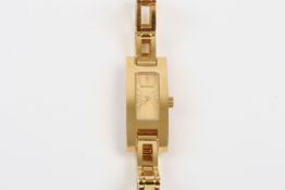 A ladies gilt metal Gucci cocktail watch, of rectangular form with baton numerals and rectangular