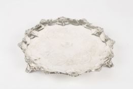 A Victorian silver circular salver, hallmarked London 1859, with central engraved crest surrounded