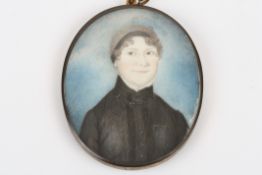 A Regency miniature mourning portrait of a lady, painted on ivory, with a black band in her hair